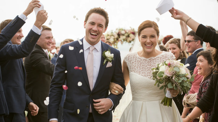 A just-married couple walking back up the aisle in celebration
