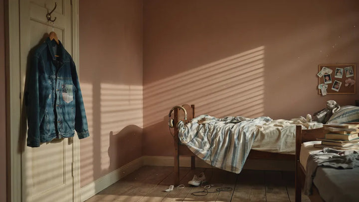 A worn jacket and headphones in a shared childhood bedroom — memorial song for a brother