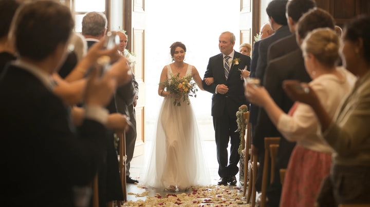A bride walking down the aisle in soft morning light