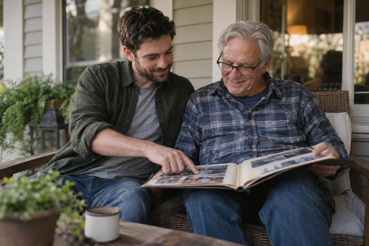 A father and adult son looking through a photo album.