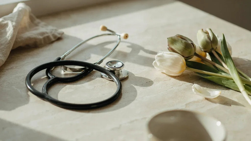 A stethoscope coiled beside tulips — custom thank-you songs for nurses | Songbond