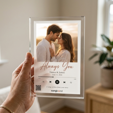 Custom Song Acrylic Plaque on its wooden LED base, shown in a warm home setting (Songbond)