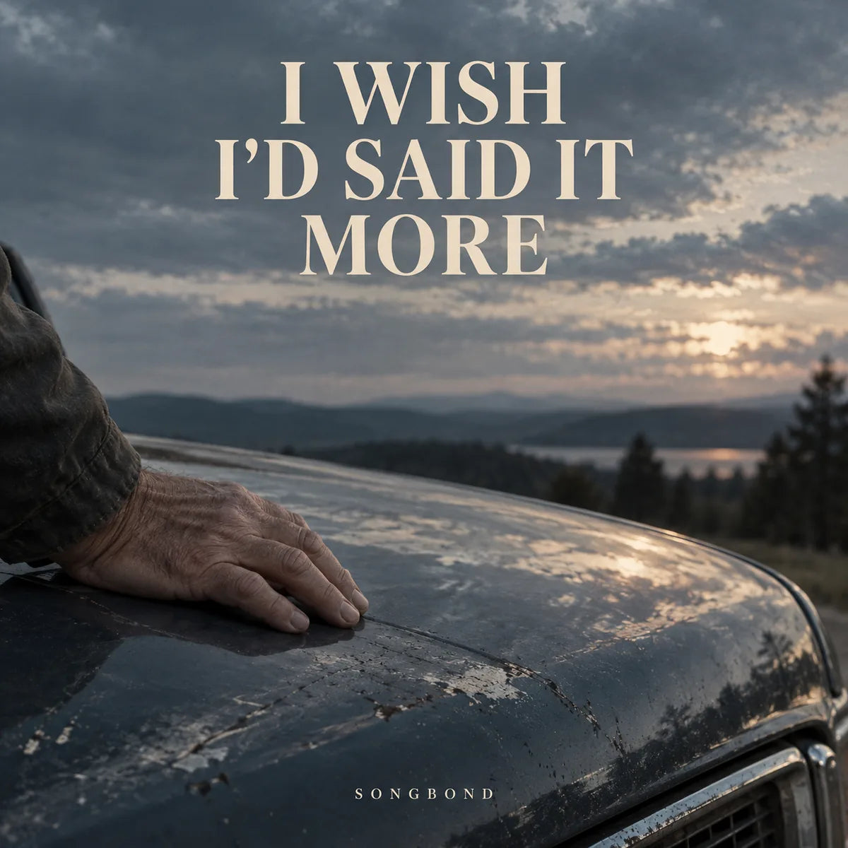 Music cover for I Wish I'd Said It More by Songbond, with a mature hand on a weathered blue car hood beneath a muted dawn sky and large cream title.