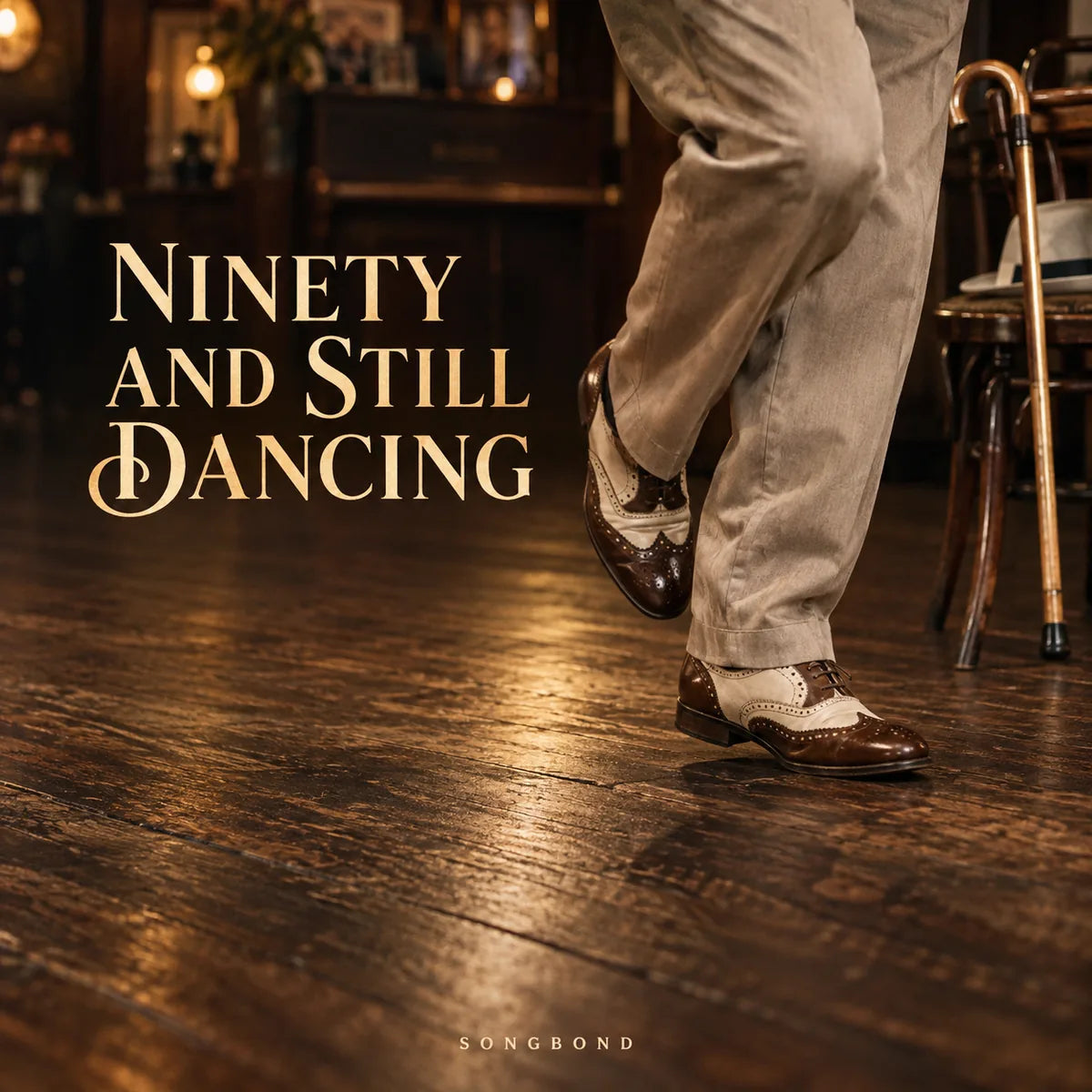 Music cover for Ninety and Still Dancing by Songbond, with dancing shoes and trouser legs over a warm wooden floor and a cane beside a chair, with gold serif title.