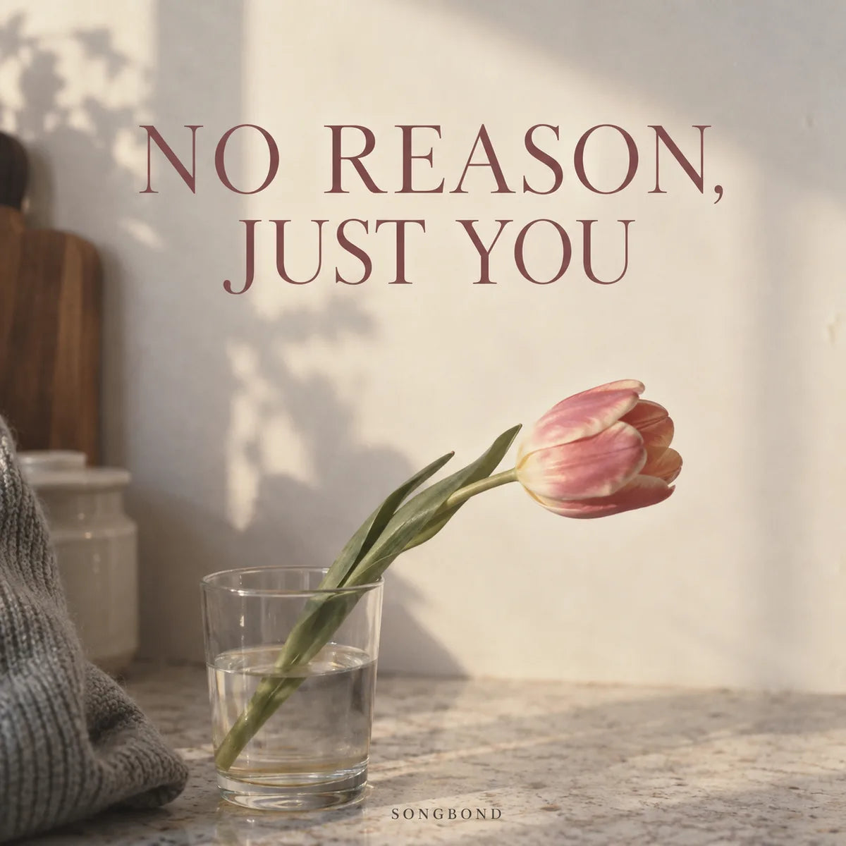 Music cover for No Reason, Just You by Songbond, with a single pink tulip in a drinking glass on a warm kitchen counter beneath a rose-colored title.