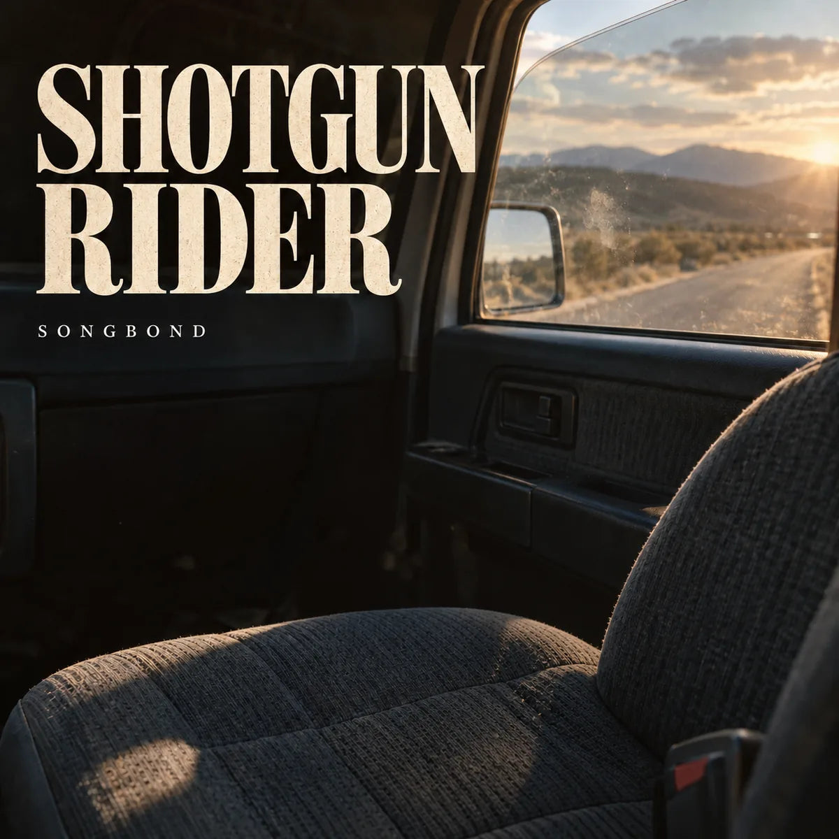 Music cover for Shotgun Rider by Songbond, with a bare worn car passenger seat, faint paw-like marks on the window and a sunlit road beneath a large cream title.