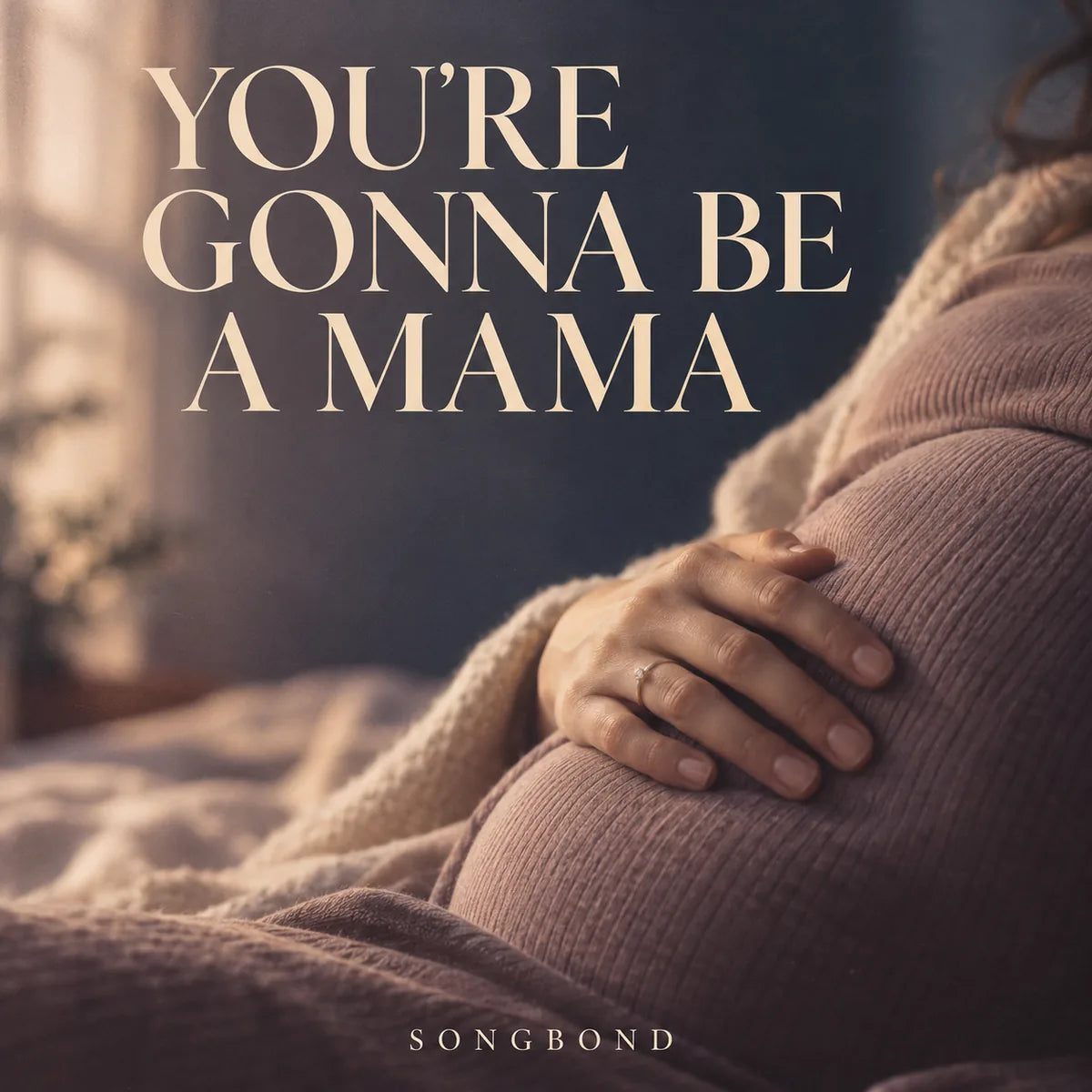 Music cover for You're Gonna Be A Mama: a pregnant adult woman's hand rests gently on her clothed belly in soft mauve and cream light beneath the complete serif title.